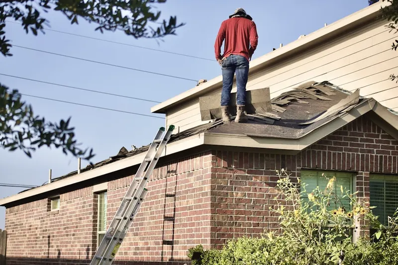 Professional roofer working on a residential roof in Pocasset Station